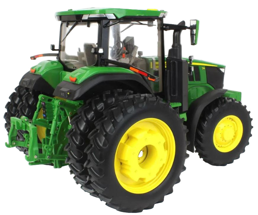 Green toy tractor with large black tires and yellow rims on a white background