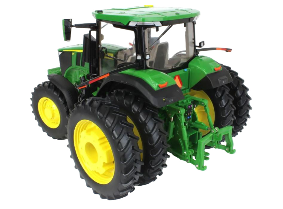 Model of a green tractor with large black and yellow wheels on a white background