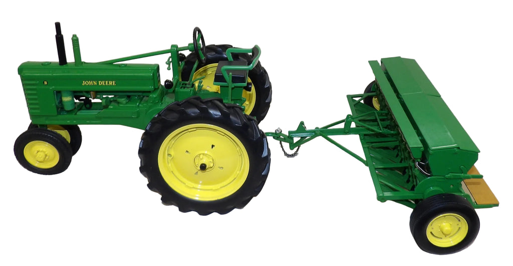 Model John Deere tractor with a plow on a white background